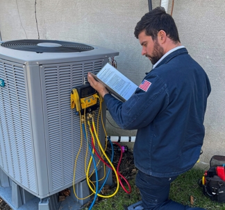 tech works on an HVAC